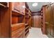 Spacious walk-in closet featuring custom wood shelving and drawers for maximum storage and organization at 3585 Tobias Ln, Las Vegas, NV 89120