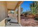 View of a covered patio with outdoor grill overlooking the spacious gravel yard at 3741 Lily Haven Ave, Las Vegas, NV 89120