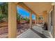 View of a covered patio featuring many stone pillars and a gravel backyard at 3741 Lily Haven Ave, Las Vegas, NV 89120