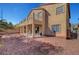 Gravel backyard with patio under an upper level deck, and desert landscaping at 3741 Lily Haven Ave, Las Vegas, NV 89120