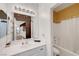 Well-lit bathroom featuring a white vanity with a large mirror and a separate shower/tub combo at 3741 Lily Haven Ave, Las Vegas, NV 89120