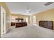 Spacious bedroom with neutral carpet, ceiling fan, and a large wooden bed frame at 3741 Lily Haven Ave, Las Vegas, NV 89120