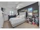 Bright bedroom with a textured accent wall, ceiling fan, and dresser at 3741 Lily Haven Ave, Las Vegas, NV 89120