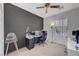 A modern bedroom with a dark accent wall and sleek office space at 3741 Lily Haven Ave, Las Vegas, NV 89120