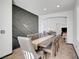 Elegant dining room featuring a long table and modern accent wall design at 3741 Lily Haven Ave, Las Vegas, NV 89120