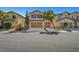 Attractive exterior elevation with a three-car garage and desert landscaping at 3741 Lily Haven Ave, Las Vegas, NV 89120