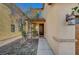 Inviting front entrance with a covered porch, enhanced by manicured landscaping and stylish exterior lighting at 3741 Lily Haven Ave, Las Vegas, NV 89120