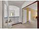 Hallway with an archway overlooking staircase, with decorative lanterns and a view into another room at 3741 Lily Haven Ave, Las Vegas, NV 89120