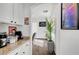 Hallway with white cabinets, granite counters, coffee station, and decorative greenery at 3741 Lily Haven Ave, Las Vegas, NV 89120