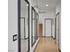 Bright hallway featuring mirrors, neutral tile flooring, and access to the staircase at 3741 Lily Haven Ave, Las Vegas, NV 89120