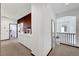 Upper hallway featuring white cabinetry, modern decor, and a view of the staircase at 3741 Lily Haven Ave, Las Vegas, NV 89120