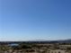 Wide shot of a distant body of water surrounded by desert vegetation at 3883 Desert Marina Dr # 245, Laughlin, NV 89029