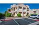 Well-maintained condo exterior with a parking area and landscaped grounds at 3883 Desert Marina Dr # 245, Laughlin, NV 89029