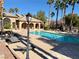 Inviting community pool surrounded by lounge chairs and lush palm trees, creating a resort-like atmosphere at 4058 Helens Pouroff Ave, North Las Vegas, NV 89085