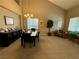 Dining room featuring high ceilings, a chandelier, and views of the backyard through the window at 4058 Helens Pouroff Ave, North Las Vegas, NV 89085