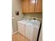 Bright laundry room with cabinetry and white washer and dryer at 4058 Helens Pouroff Ave, North Las Vegas, NV 89085