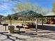 Park featuring picnic tables under a shaded structure and nearby playground equipment for Gathering gatherings at 4058 Helens Pouroff Ave, North Las Vegas, NV 89085