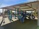 Covered playground area with modern equipment, swings, and climbing structures, offering a safe play area for  at 4058 Helens Pouroff Ave, North Las Vegas, NV 89085