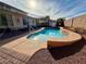 Backyard pool with lounge chairs and lush foliage, creating a private oasis for relaxing and entertaining at 4058 Helens Pouroff Ave, North Las Vegas, NV 89085