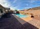 Outdoor living is showcased with a pristine pool and brick patio at 4058 Helens Pouroff Ave, North Las Vegas, NV 89085