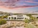 Expansive home featuring a well-manicured lawn, desert landscaping and inviting pool area at 41 Crested Cloud Way, Las Vegas, NV 89135