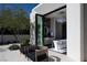 Luxurious bathroom with a freestanding tub visible from the patio with chairs and desert landscaping at 41 Crested Cloud Way, Las Vegas, NV 89135