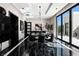 Sophisticated dining area with dark marble floors, modern lighting, and seamless indoor/outdoor flow at 41 Crested Cloud Way, Las Vegas, NV 89135