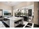 Modern kitchen featuring an island, black and white patterned floors, and stainless steel bar stools at 41 Crested Cloud Way, Las Vegas, NV 89135