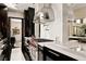 Contemporary kitchen with a sleek range hood and countertops, a stylish range, and black and white tile floors at 41 Crested Cloud Way, Las Vegas, NV 89135