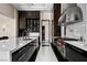 Modern kitchen featuring stainless steel appliances, sleek countertops, and patterned flooring at 41 Crested Cloud Way, Las Vegas, NV 89135