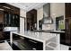 Stylish kitchen featuring stainless steel appliances, a kitchen island, and custom cabinetry at 41 Crested Cloud Way, Las Vegas, NV 89135