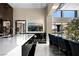 Modern kitchen featuring a large island and bar, sleek countertops, and high-end appliances at 41 Crested Cloud Way, Las Vegas, NV 89135