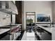 Modern kitchen featuring stainless steel appliances and fixtures, sleek countertops, and patterned flooring at 41 Crested Cloud Way, Las Vegas, NV 89135