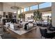 Bright living room featuring sleek black and white furniture, decorous fixtures, and an open floor plan at 41 Crested Cloud Way, Las Vegas, NV 89135