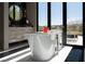 View of the elegant main bathroom with a soaking tub and a view of the backyard at 41 Crested Cloud Way, Las Vegas, NV 89135