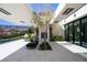 Stylish outdoor living space featuring a central tree, sleek design, and a tranquil pool view at 41 Crested Cloud Way, Las Vegas, NV 89135