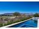 Scenic view of the pool overlooking lush greenery and distant mountains, creating a tranquil retreat at 41 Crested Cloud Way, Las Vegas, NV 89135