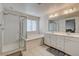 Bathroom with double sinks, glass shower and a separate garden tub at 4115 Spring Storm Ave, North Las Vegas, NV 89081