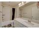 Bathroom showcasing a white vanity, framed mirror, and shower-tub combo at 4115 Spring Storm Ave, North Las Vegas, NV 89081