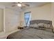 Bedroom with a ceiling fan, closet doors, and a grey upholstered headboard at 4115 Spring Storm Ave, North Las Vegas, NV 89081