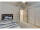 Neutral bedroom with a twin bed, closet doors, and an interior door at 4115 Spring Storm Ave, North Las Vegas, NV 89081