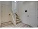 Bright foyer featuring wood-look flooring, staircase, and a white front door at 4115 Spring Storm Ave, North Las Vegas, NV 89081