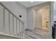 Bright foyer with wood-look flooring, a staircase, and entryways to other rooms at 4115 Spring Storm Ave, North Las Vegas, NV 89081