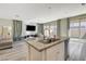 Kitchen island features a granite countertop, stainless steel dishwasher, and a stainless sink at 4115 Spring Storm Ave, North Las Vegas, NV 89081