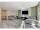 Bright living room offers gray wood floors and plenty of natural light at 4115 Spring Storm Ave, North Las Vegas, NV 89081