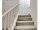 Carpeted staircase with white railing leads to the upper level at 4115 Spring Storm Ave, North Las Vegas, NV 89081