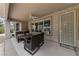 Covered back patio with patio furniture, a ceiling fan, and a security screen door at 4557 Bersaglio St, Las Vegas, NV 89135