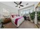 Bright bedroom with a bay window, ceiling fan, and large closet with mirrored doors at 4557 Bersaglio St, Las Vegas, NV 89135