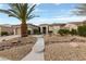 Charming home with desert landscaping, stone accents, and a concrete walkway at 4557 Bersaglio St, Las Vegas, NV 89135