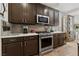 Modern kitchen with stainless steel appliances, dark cabinetry, and stylish backsplash at 4557 Bersaglio St, Las Vegas, NV 89135